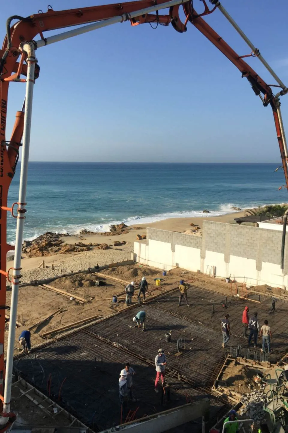 Concrete pump placing the foundation slab, ocean view, El Encanto project