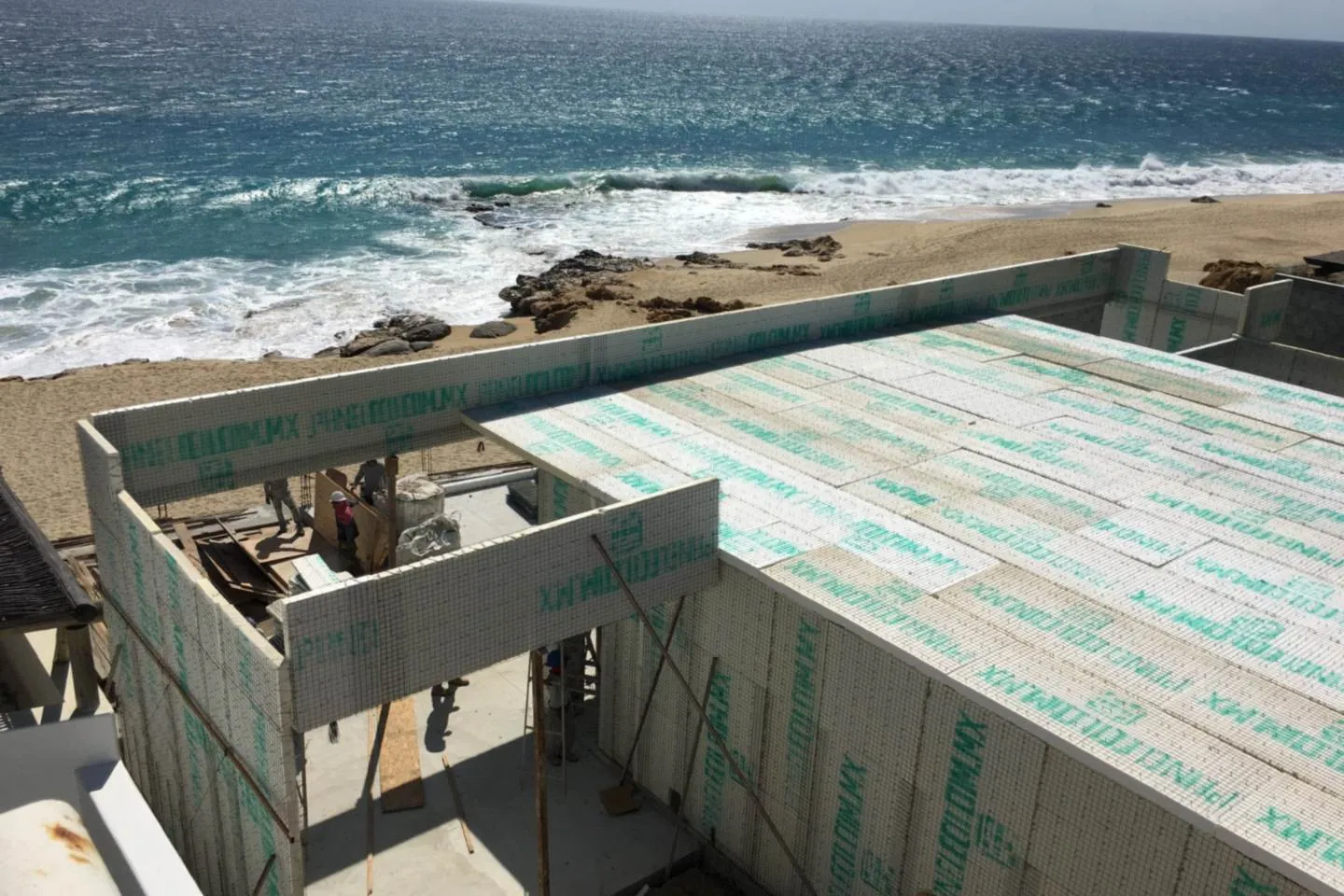 ICF wall panels under construction, ocean beyond, El Encanto project