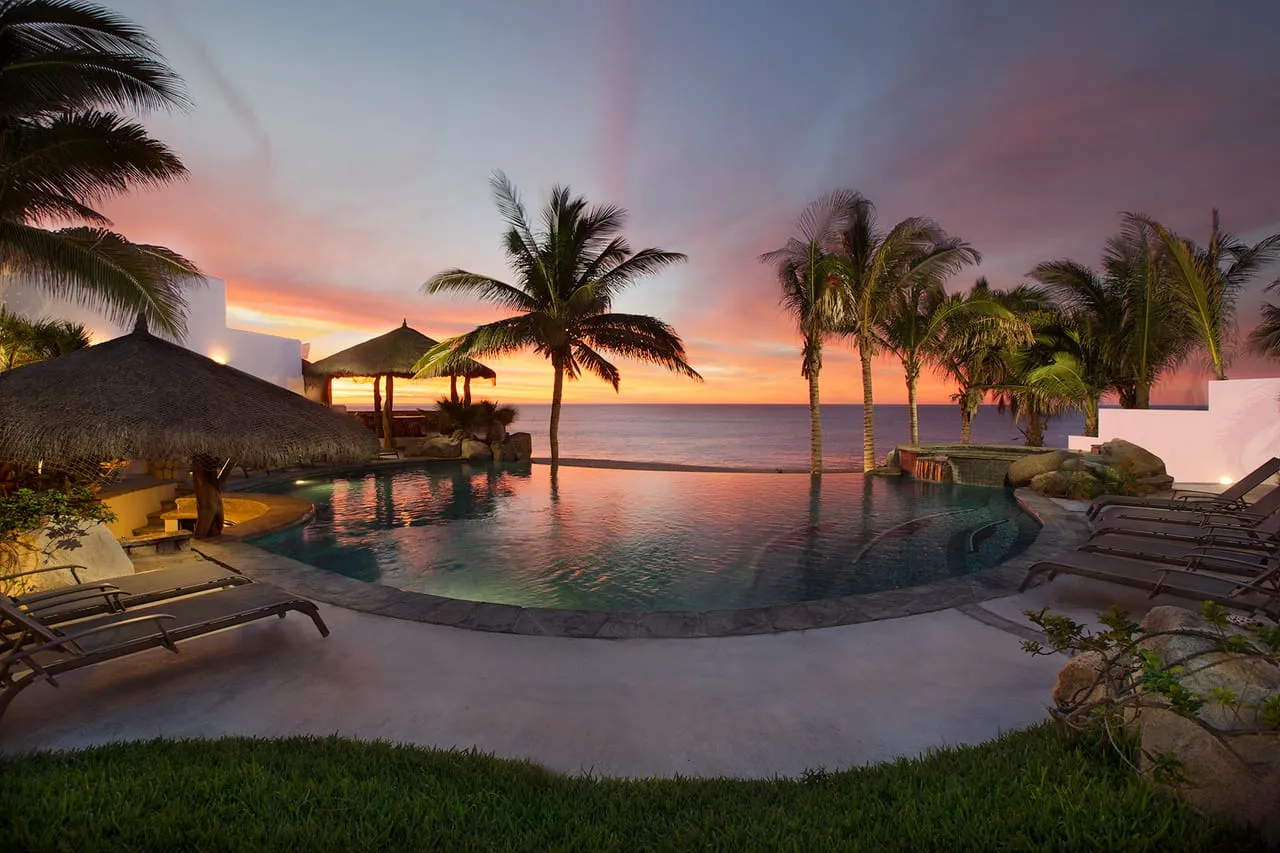 Oceanfront pool and terrace at Casa Nokes at sunset