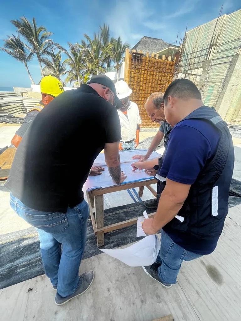 Team reviewing drawings during a site visit